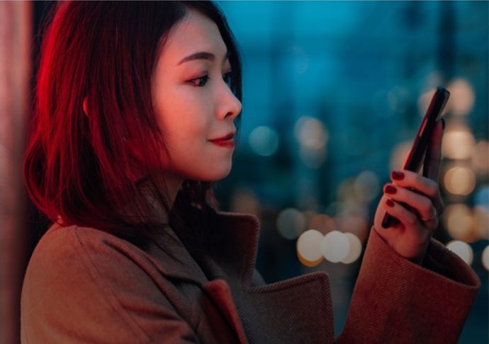 Woman smiling at her mobile phone