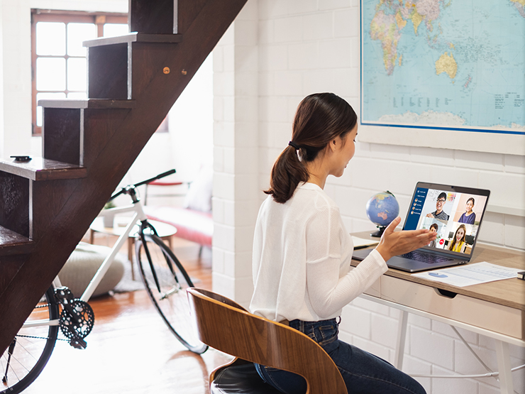 A woman looking at her laptop